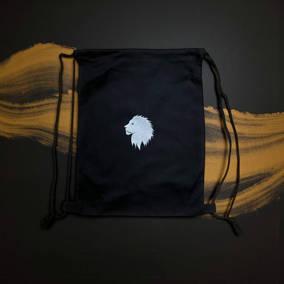 Black cotton drawstring bag with a white lion emblem on a dark background with gold accents