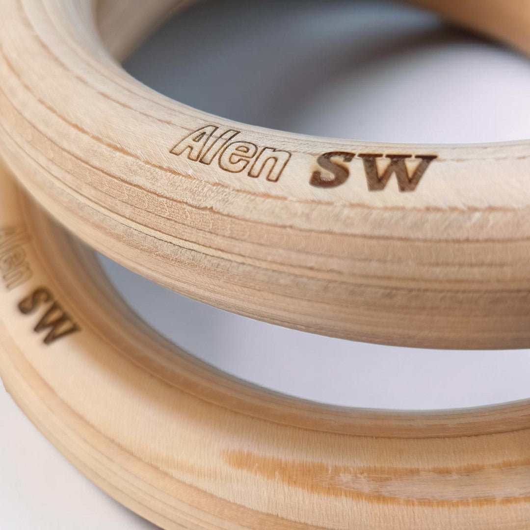 Close-up of wooden calisthenics rings with name laser engraving 