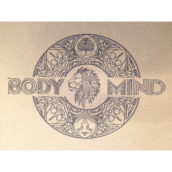 Decorative lion symbol design on a yoga cork mat surface with abstract patterns and text.