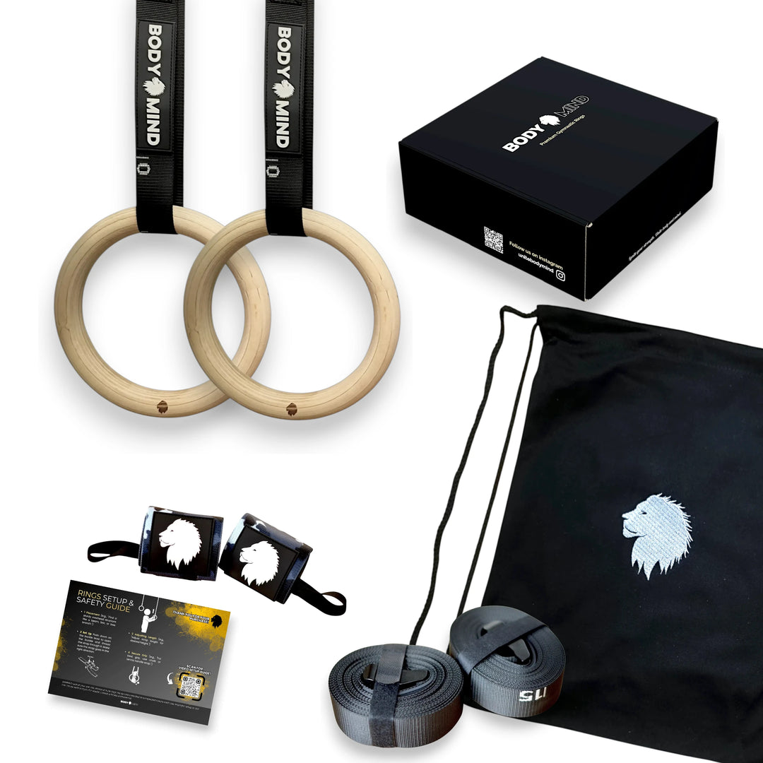 Gym equipment set including wooden rings, straps, and a black bag with branding on a white background.