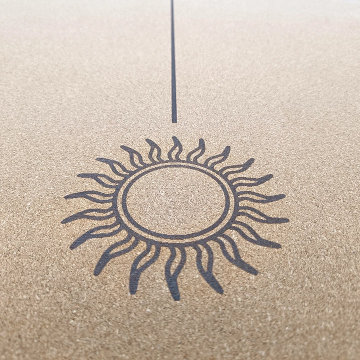 Sun symbol on a cork yoga mat
