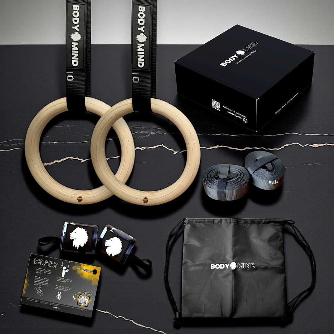 Gym equipment including wooden rings, resistance bands, and a drawstring bag.