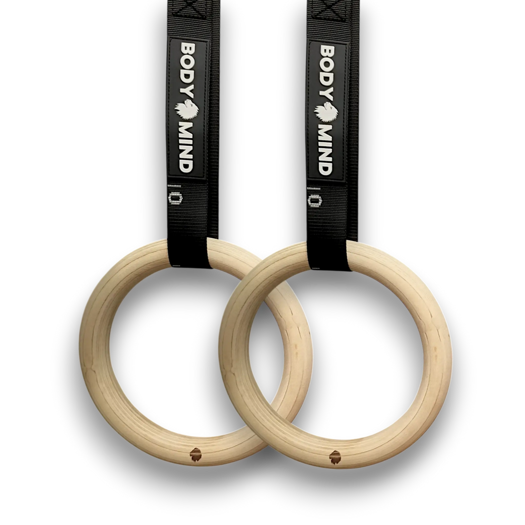 Wooden workout rings with black straps.
