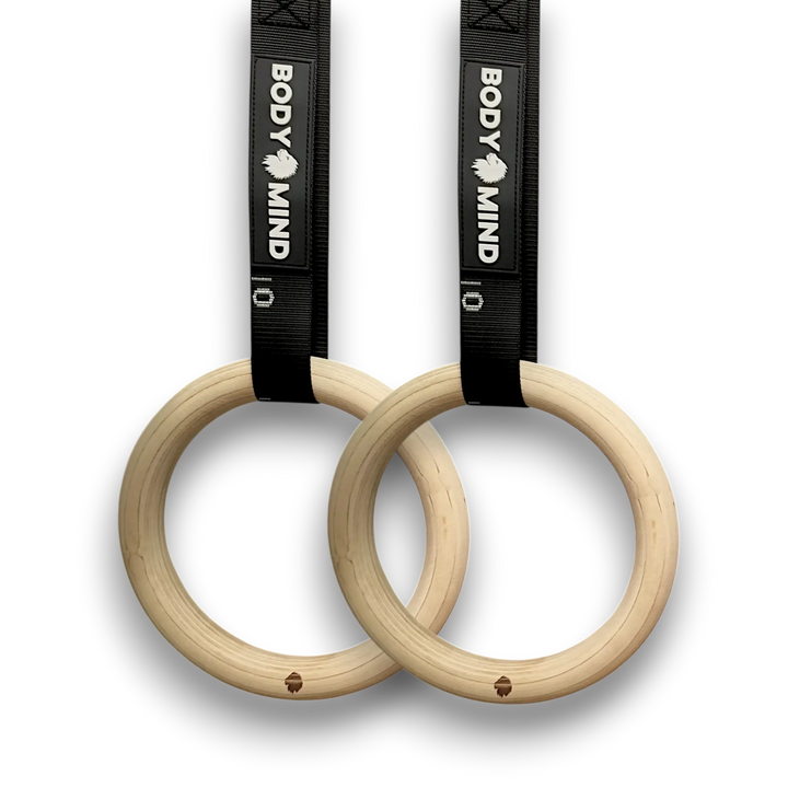 Wooden workout rings with black straps.